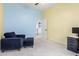 Relaxing bedroom featuring blue and yellow accent walls, comfortable seating, and ample natural light at 9548 E Grandview St, Mesa, AZ 85207