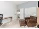 Comfortable bedroom featuring a brown leather chair with an ottoman, desk, and ample closet space at 9548 E Grandview St, Mesa, AZ 85207