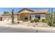 Inviting single-story home featuring desert landscaping with cacti, stone pathway, and beige stucco exterior at 9548 E Grandview St, Mesa, AZ 85207