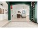 Open-concept living space with green arched columns, tiled floors, and a view of the entryway at 9548 E Grandview St, Mesa, AZ 85207