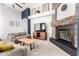 Bright living room with stone fireplace, plush seating, and modern decor at 9548 E Grandview St, Mesa, AZ 85207