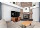 Cozy living room featuring a stone fireplace, entertainment center, and comfortable seating at 9548 E Grandview St, Mesa, AZ 85207