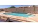 Sparkling backyard pool with stacked stone accents and a privacy wall at 9548 E Grandview St, Mesa, AZ 85207