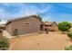 Large backyard with desert landscaping, a patio area, and partial view of the home at 11410 W Davis Ln, Avondale, AZ 85323