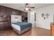 Cozy bedroom with a ceiling fan, built-in storage, and arched bathroom entry at 11410 W Davis Ln, Avondale, AZ 85323