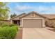 Charming single-story home with a two-car garage, landscaped front yard, and a well-maintained lawn at 11410 W Davis Ln, Avondale, AZ 85323