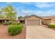 Charming single-story home with a two-car garage, landscaped front yard, and a well-maintained lawn at 11410 W Davis Ln, Avondale, AZ 85323