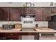 A well-equipped kitchen boasts stainless steel appliances, ample counter space, and modern lighting at 11410 W Davis Ln, Avondale, AZ 85323