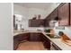 Kitchen features stainless steel appliances, and dark wood cabinets at 11410 W Davis Ln, Avondale, AZ 85323