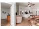 Spacious living room with tile flooring, ceiling fan, and comfortable leather seating at 11410 W Davis Ln, Avondale, AZ 85323