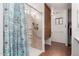 Accessible walk-in shower with grab bars, a shower seat, and a shower curtain at 11410 W Davis Ln, Avondale, AZ 85323