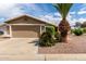 Charming single-story home featuring a two-car garage, desert landscaping, and a well-maintained front yard at 11520 W Lizard Ct, Surprise, AZ 85378