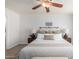 Cozy main bedroom with ceiling fan, wood floor and ensuite bathroom access at 11520 W Lizard Ct, Surprise, AZ 85378