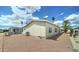 Backyard with gravel landscaping, palm trees, and a satellite dish at 11596 W Sierra Dawn Blvd # 165, Surprise, AZ 85378