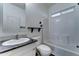 Bathroom with marble countertop, white cabinets and sink, and bathtub with white tile at 11596 W Sierra Dawn Blvd # 165, Surprise, AZ 85378