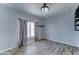 Bright bedroom with neutral flooring, curtains, and installed dark shelving at 11596 W Sierra Dawn Blvd # 165, Surprise, AZ 85378