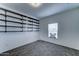 Bedroom with gray carpet, a window, and installed dark shelving at 11596 W Sierra Dawn Blvd # 165, Surprise, AZ 85378