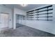 Bright bedroom with built in shelving, sliding mirror closet doors and gray carpeting at 11596 W Sierra Dawn Blvd # 165, Surprise, AZ 85378