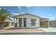 Charming manufactured home with covered porch and carport, featuring a desert landscape at 11596 W Sierra Dawn Blvd # 165, Surprise, AZ 85378