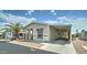 Manufactured home featuring a carport, covered porch, and desert landscaping at 11596 W Sierra Dawn Blvd # 165, Surprise, AZ 85378