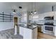 Modern kitchen with stainless steel appliances, center island, and access to a storage room at 11596 W Sierra Dawn Blvd # 165, Surprise, AZ 85378