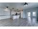 Open-concept living and kitchen area, featuring new flooring and modern lighting fixtures at 11596 W Sierra Dawn Blvd # 165, Surprise, AZ 85378