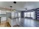 Open-concept living room and kitchen with pendant lighting and modern white cabinetry at 11596 W Sierra Dawn Blvd # 165, Surprise, AZ 85378