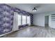 Living room with modern gray walls, updated flooring, and natural light from large windows at 11596 W Sierra Dawn Blvd # 165, Surprise, AZ 85378