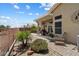 Spacious backyard features desert landscape, covered patio, and brick pavers, perfect for outdoor gatherings at 11650 W Pincushion Ct, Surprise, AZ 85378