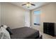 Calm bedroom featuring carpeted floors, ceiling fan, single window with shade, and a dark dresser at 11650 W Pincushion Ct, Surprise, AZ 85378