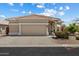 Attractive single-story home showcasing a two-car garage and desert landscaping at 11650 W Pincushion Ct, Surprise, AZ 85378