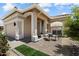 Charming home exterior featuring a cozy seating area and well-maintained landscaping at 11650 W Pincushion Ct, Surprise, AZ 85378