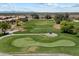 Aerial view of a well-maintained golf course with a player and a golf cart at 11650 W Pincushion Ct, Surprise, AZ 85378