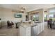 Bright, open kitchen features a granite island, stainless steel appliances, and seamless flow to the living area at 11650 W Pincushion Ct, Surprise, AZ 85378