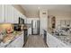Stylish kitchen featuring white cabinetry, granite countertops, and stainless steel appliances at 11650 W Pincushion Ct, Surprise, AZ 85378