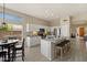 Modern kitchen with white cabinets, granite countertops, stainless steel appliances, and island seating at 11650 W Pincushion Ct, Surprise, AZ 85378