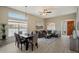 Bright living space featuring dining area, comfortable seating, and large windows at 11650 W Pincushion Ct, Surprise, AZ 85378