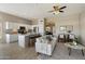 Bright living space with open kitchen, ample seating, and stylish decor at 11650 W Pincushion Ct, Surprise, AZ 85378
