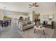 Open-concept living area with modern kitchen, dining space, and comfortable seating at 11650 W Pincushion Ct, Surprise, AZ 85378