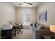Functional office features a long gray couch, large desk, carpeted floors, and lots of natural light at 11650 W Pincushion Ct, Surprise, AZ 85378