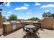 Outdoor patio featuring a built-in kitchen with dual grills and a table with seating at 11650 W Pincushion Ct, Surprise, AZ 85378