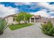 Backyard oasis featuring a well-manicured lawn, desert landscaping and a hammock at 1170 E Jardin Dr, Casa Grande, AZ 85122