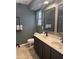 Bathroom featuring double sinks, modern fixtures, and neutral paint, with a separate door to the lavatory at 1170 E Jardin Dr, Casa Grande, AZ 85122