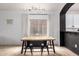 Well-lit dining room with a modern light fixture and an archway to the kitchen at 1170 E Jardin Dr, Casa Grande, AZ 85122