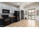Well lit kitchen with modern appliances, subway tile backsplash, and sliding door access to a patio at 1170 E Jardin Dr, Casa Grande, AZ 85122