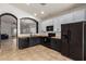 Open kitchen featuring sleek appliances, butcher block countertops, and seamless flow to the living area at 1170 E Jardin Dr, Casa Grande, AZ 85122