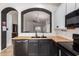 Stylish kitchen with black countertops, ample storage, and views into the living area at 1170 E Jardin Dr, Casa Grande, AZ 85122