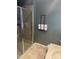 Bathroom featuring a glass-enclosed shower and neutral paint, with a towel rack and storage at 1170 E Jardin Dr, Casa Grande, AZ 85122