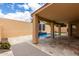 Covered patio overlooking a backyard with a sparkling pool and stone pavers at 11808 E Clinton St, Scottsdale, AZ 85259