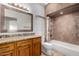 Well-lit bathroom features a granite countertop vanity and tile surround bathtub at 11808 E Clinton St, Scottsdale, AZ 85259